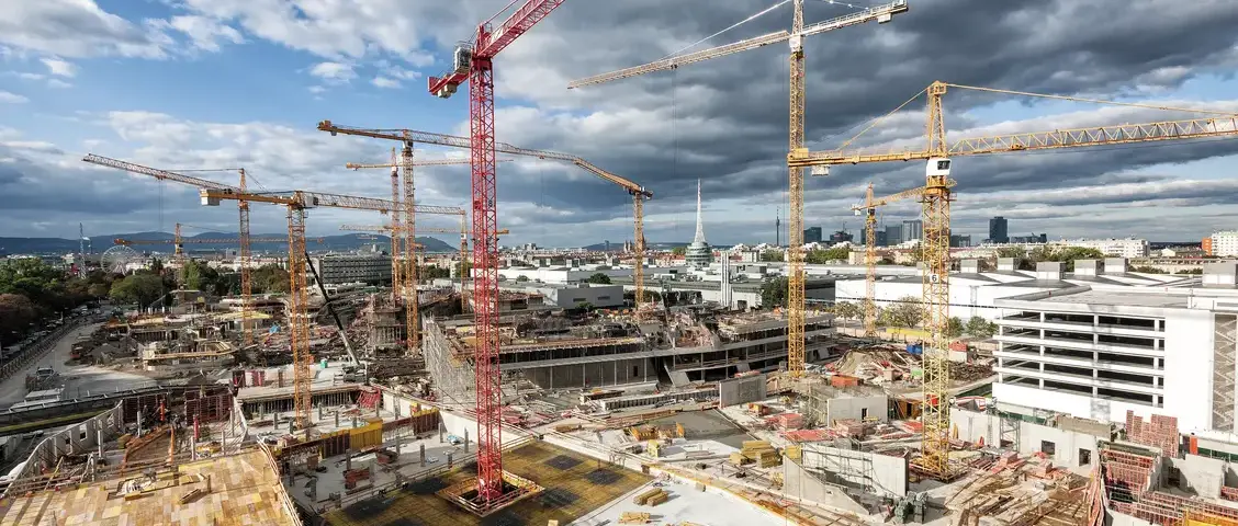 Large construction project with multiple tower cranes — the kind of complex jobsite a wrap-up insurance program may cover