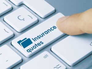Finger pressing an “Insurance quotes” key on a keyboard