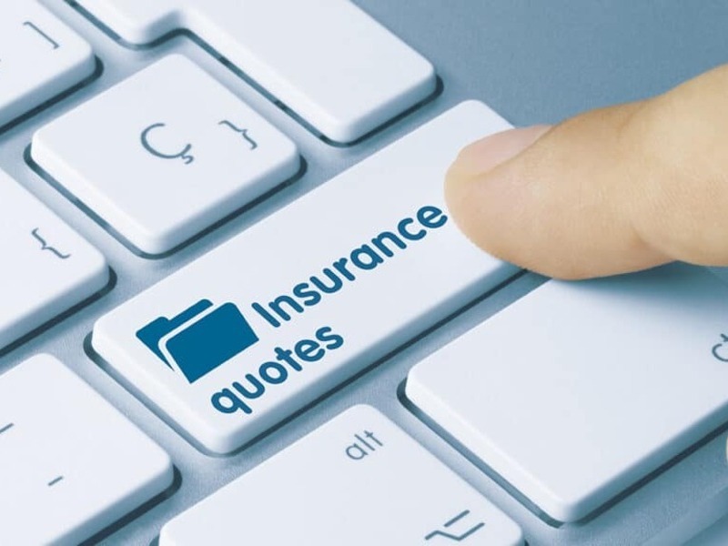 Finger pressing an “Insurance quotes” key on a keyboard