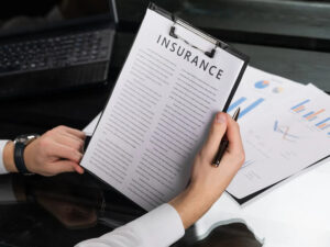 Person reviewing an insurance policy on a clipboard