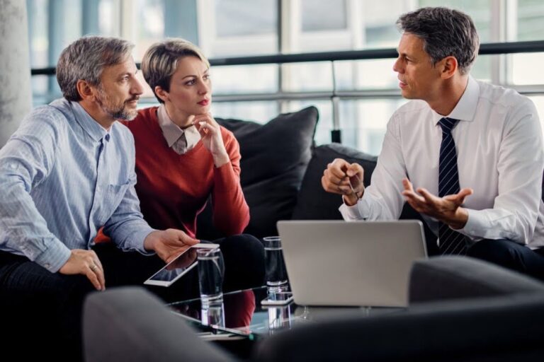Insurance advisor meeting with clients to review coverage and discuss recovery after a major loss