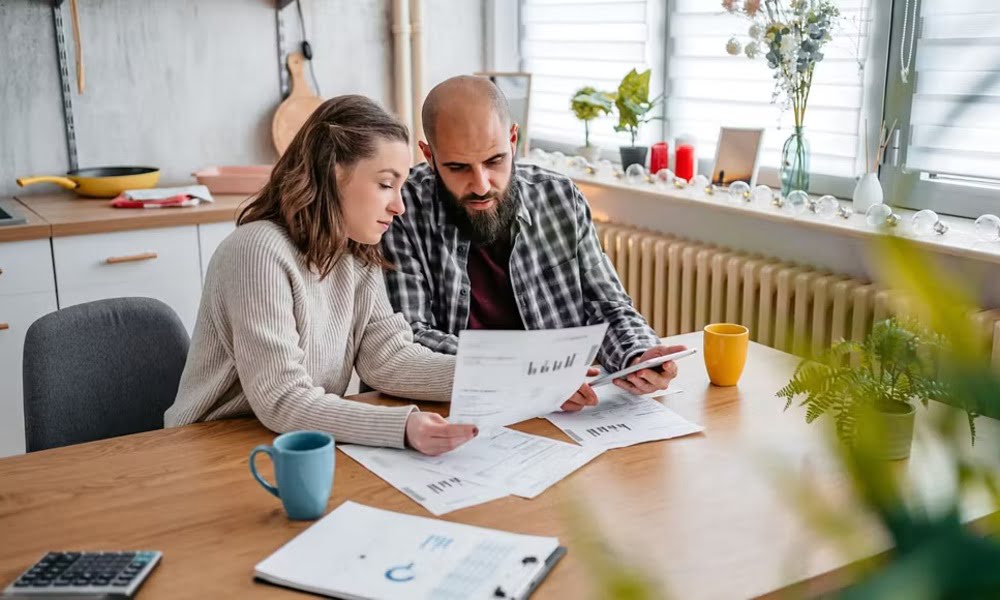 Couple reviewing insurance documents at home to avoid common claims and coverage issues