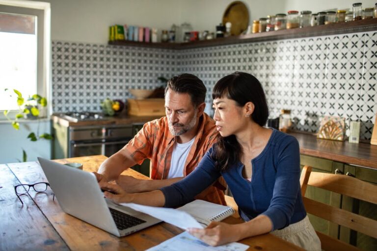 Couple reviewing insurance coverage at home after a major life change