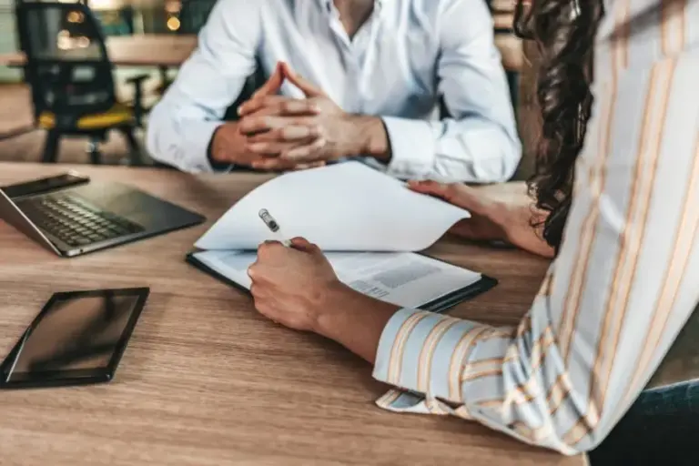 Business owners reviewing contract documents and additional insured insurance requirements