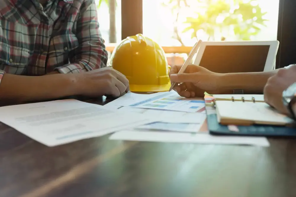 Contractor reviewing construction insurance documents during a wrap-up program meeting