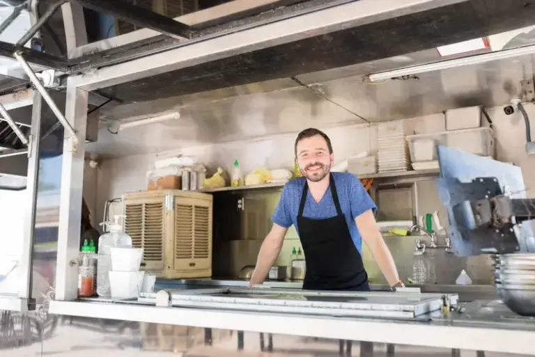 Food truck owner operating a mobile kitchen covered by business insurance
