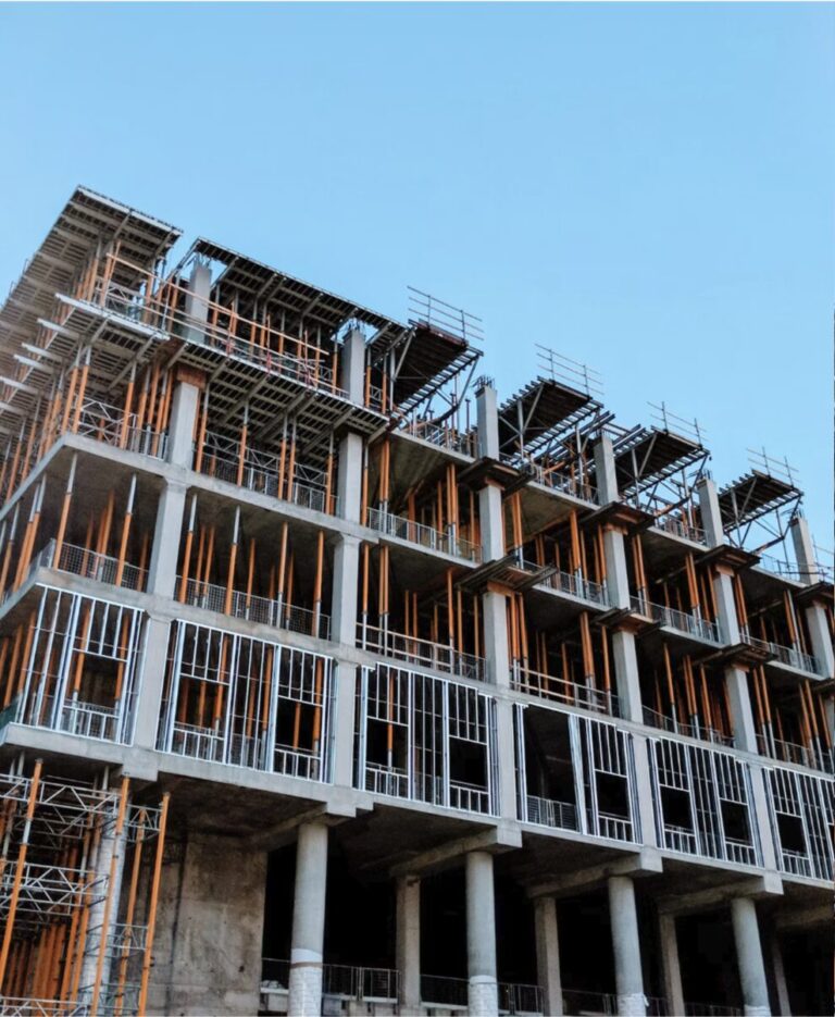 Multi-story building under construction with exposed steel and concrete framing, representing California builders risk insurance coverage during active construction.