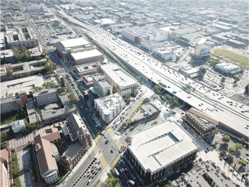 Aerial view of a city highway interchange, representing multi-state commercial insurance considerations for California and Texas contractors.