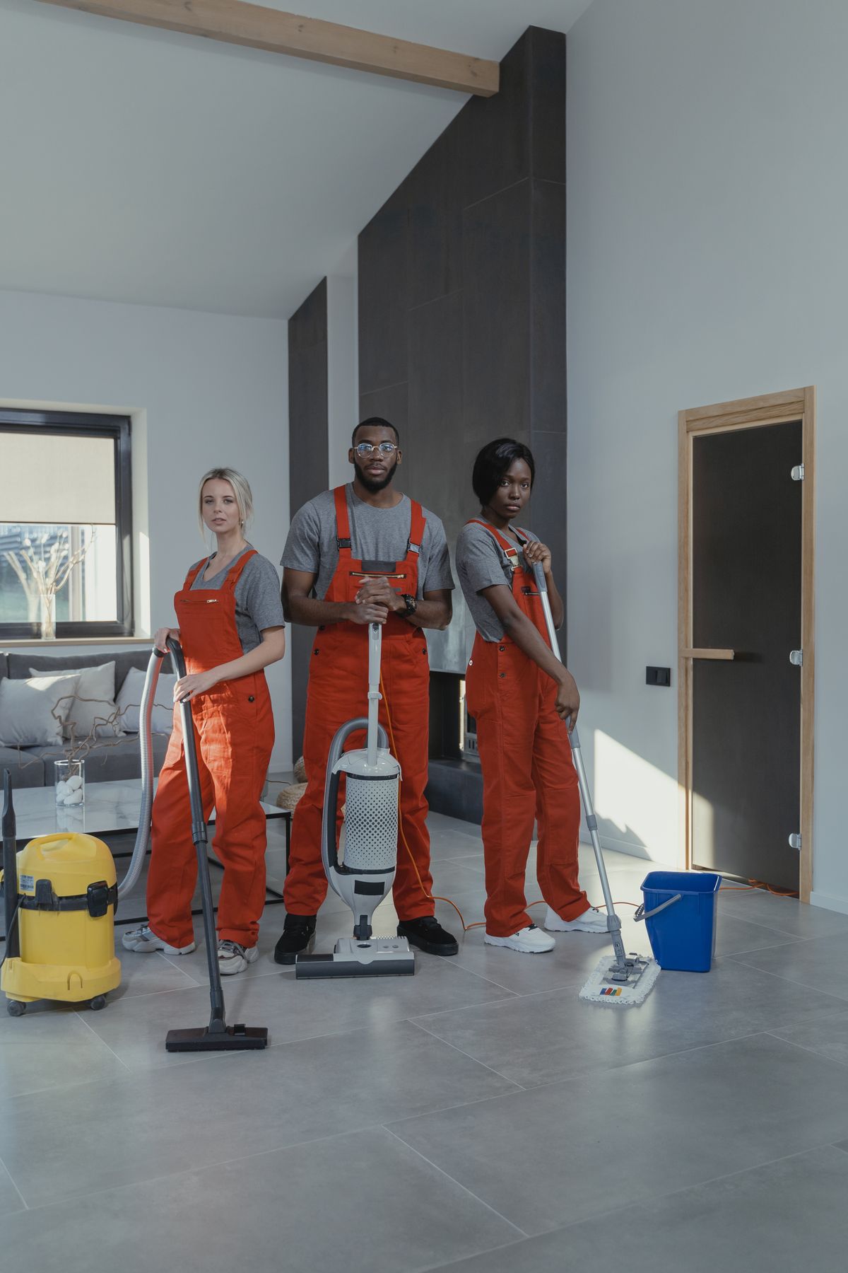 Professional cleaners with equipment inside a client home