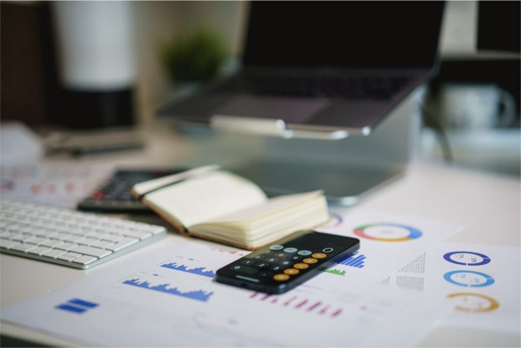Financial charts and a calculator on a desk, representing the wrap-up insurance feasibility scoring calculator.