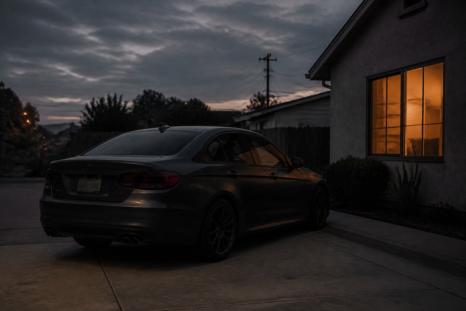 Sedan in a driveway at dusk